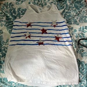 A red white and blue tank top with a cross back aswell as flipping sequence.